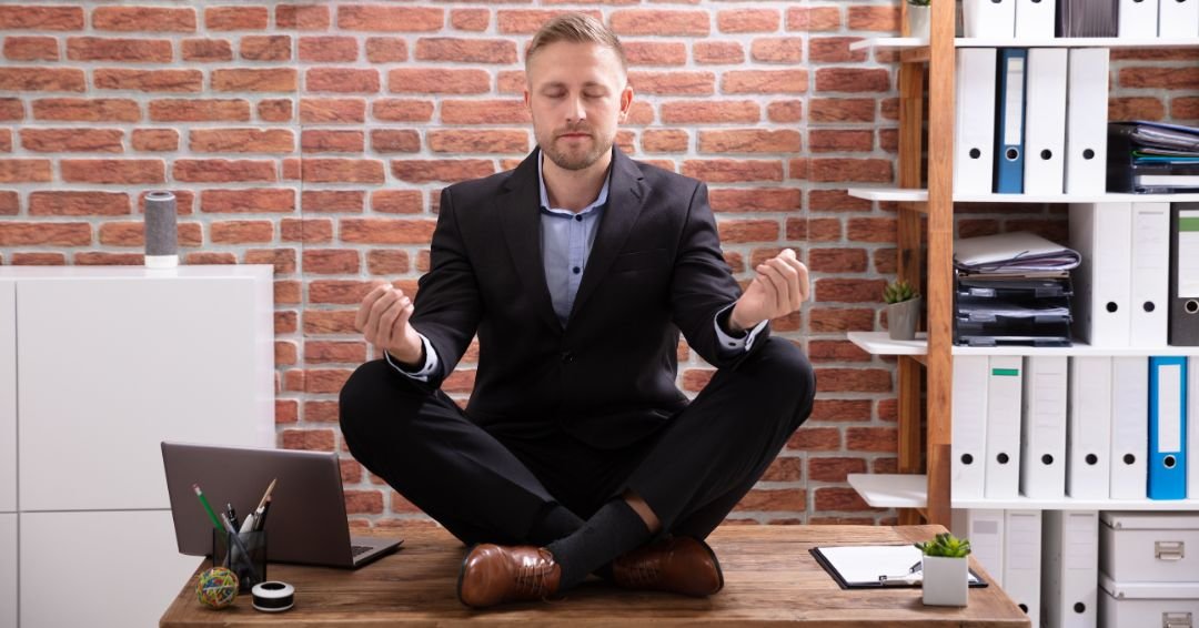 hombre de traje, meditando sobre su escritorio de trabajo